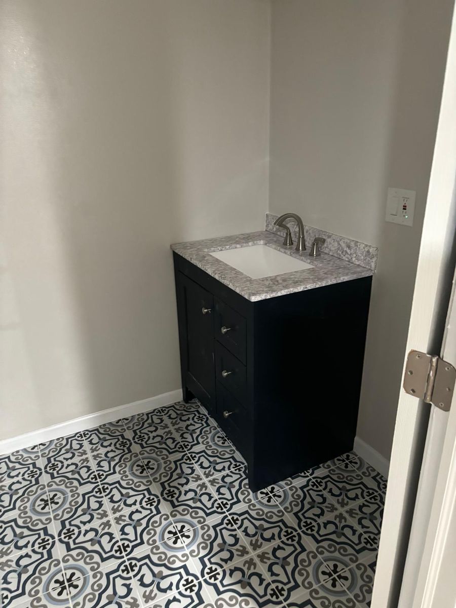Patterned floor tile with a navy vanity