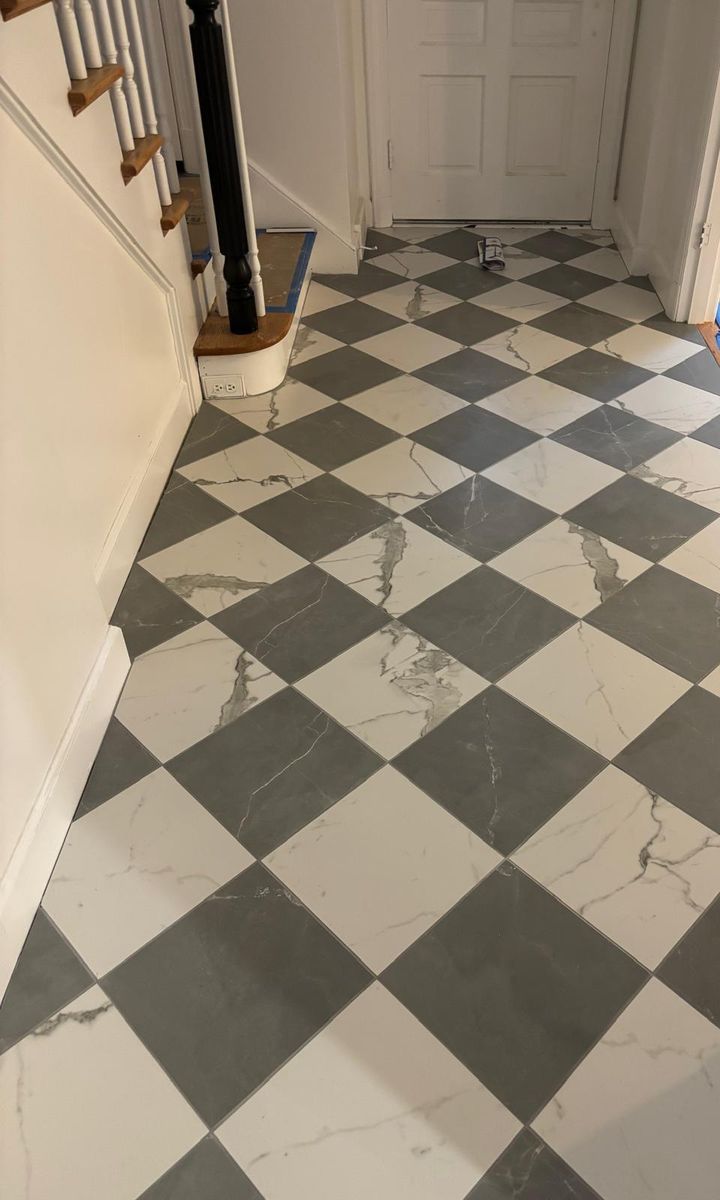 Black and white checkerboard tile floor in a hallway
