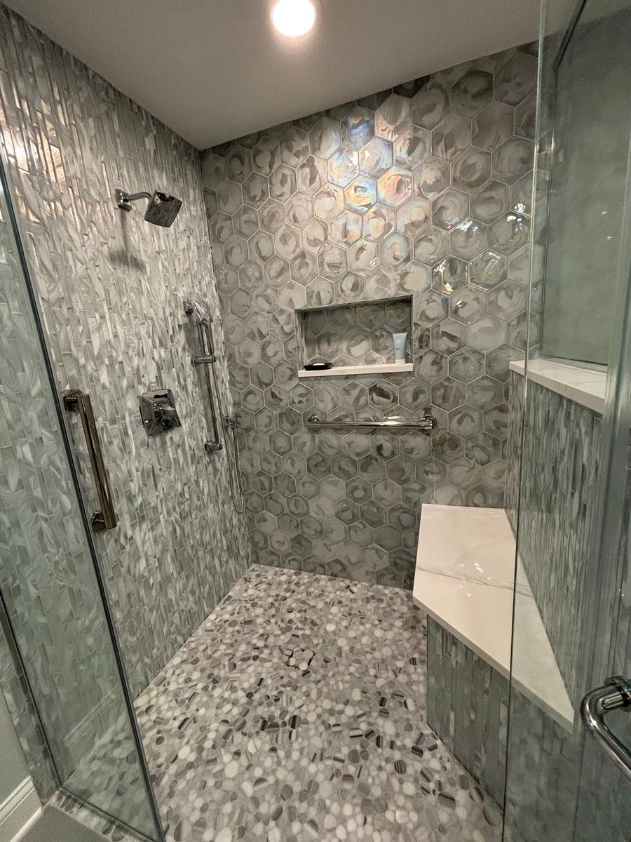 Mosaic tile shower with built-in bench and niche